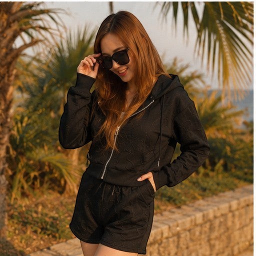 THREE PEACE black Y2K lounge set with cropped zip-up hoodie and shorts, featuring jacquard monogram pattern.