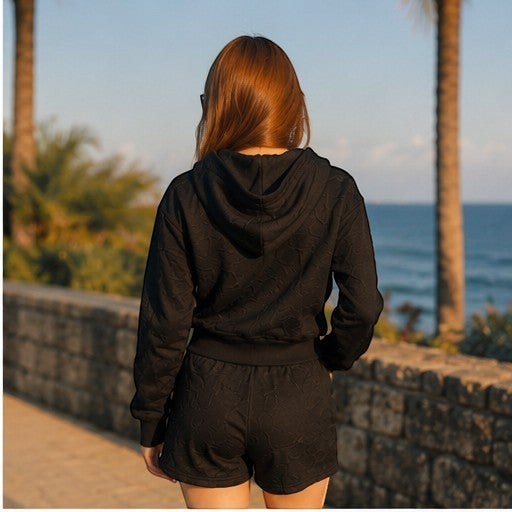 THREE PEACE black Y2K lounge set with cropped zip-up hoodie and shorts, featuring jacquard monogram pattern. Polyester.